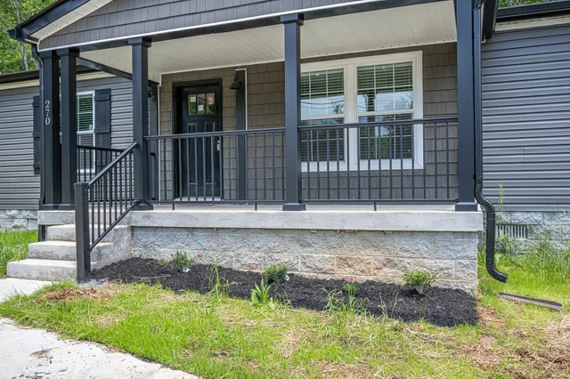 a front view of a house with a yard