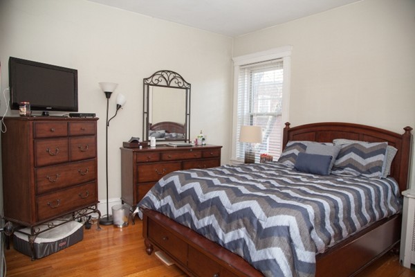 30 Kilsyth Road, Unit 23 Brookline, MA 02445 - Photo 4 of 4 a bedroom with a bed and flat screen tv