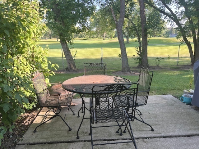 744 Old Checker Road Buffalo Grove, IL 60089 - Photo 3 of 4 a view of a porch with furniture and a yard