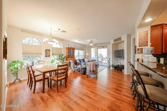 a dining room with furniture window and wooden floor