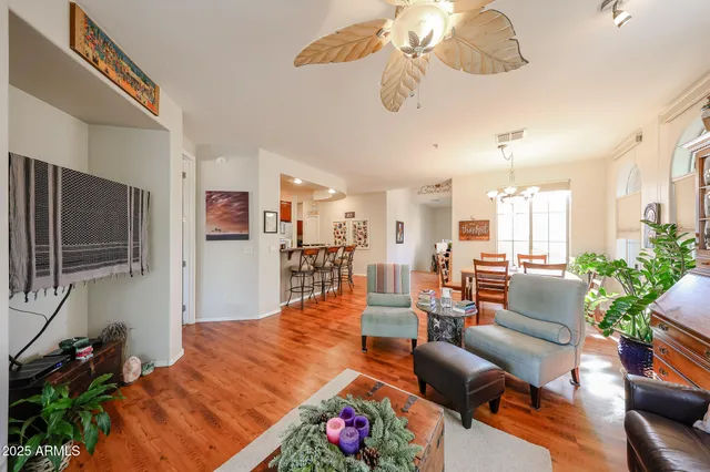 a living room with furniture kitchen view and a flat screen tv