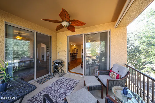 a living room with furniture a rug and a large window