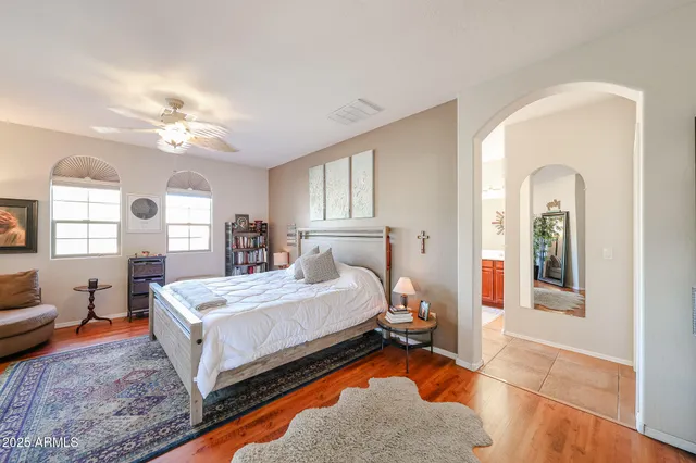 a bedroom with a large bed and a chandelier