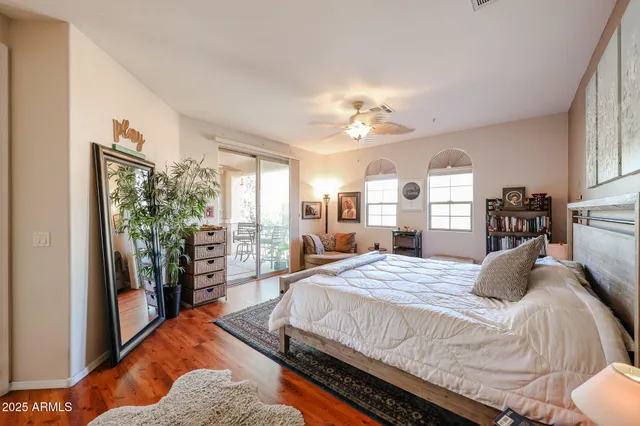 a bedroom with a large bed and a chandelier