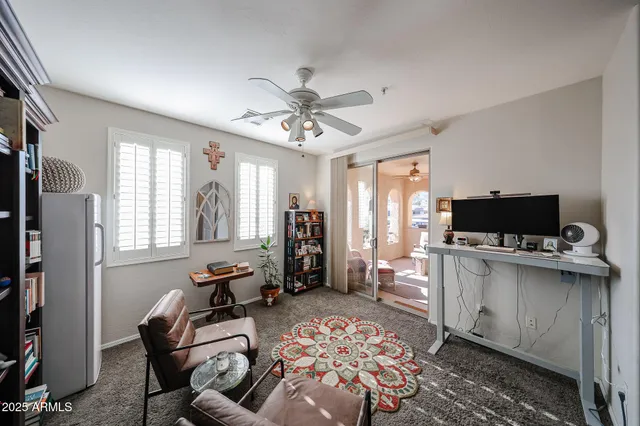 a living room with furniture and a book shelf