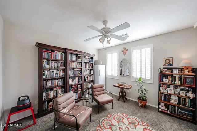 a living room with furniture a flat screen tv and kitchen view
