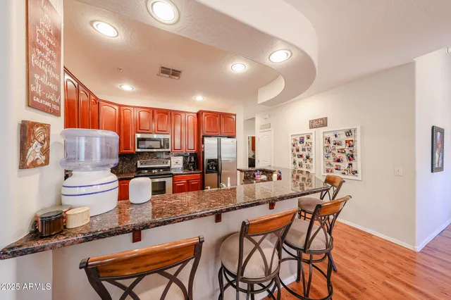 a large kitchen with a table and chairs