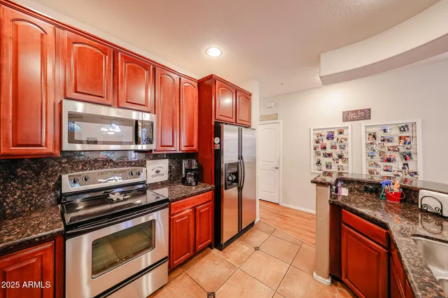 a kitchen with stainless steel appliances a stove sink and refrigerator