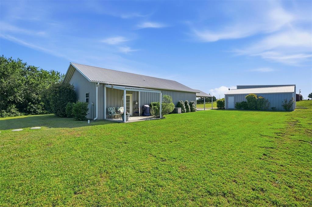15656 South State Highway 78 Blue Ridge, TX 75424 - Photo 30 of 36 a view of house in front of a big yard with potted plants and large trees