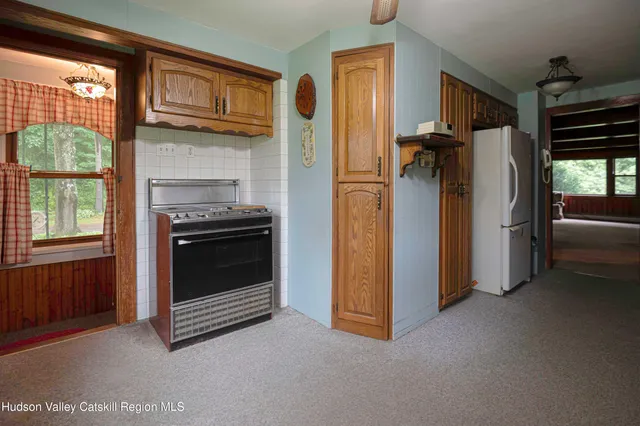 a view of an empty room with a fireplace and a window