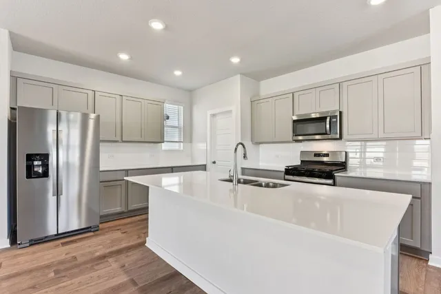 a kitchen with stainless steel appliances granite countertop a sink stove microwave and cabinets