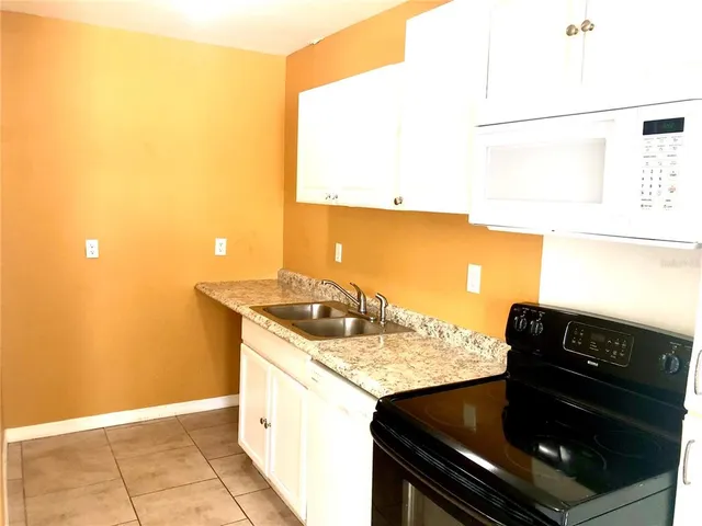 a kitchen with a sink and a stove