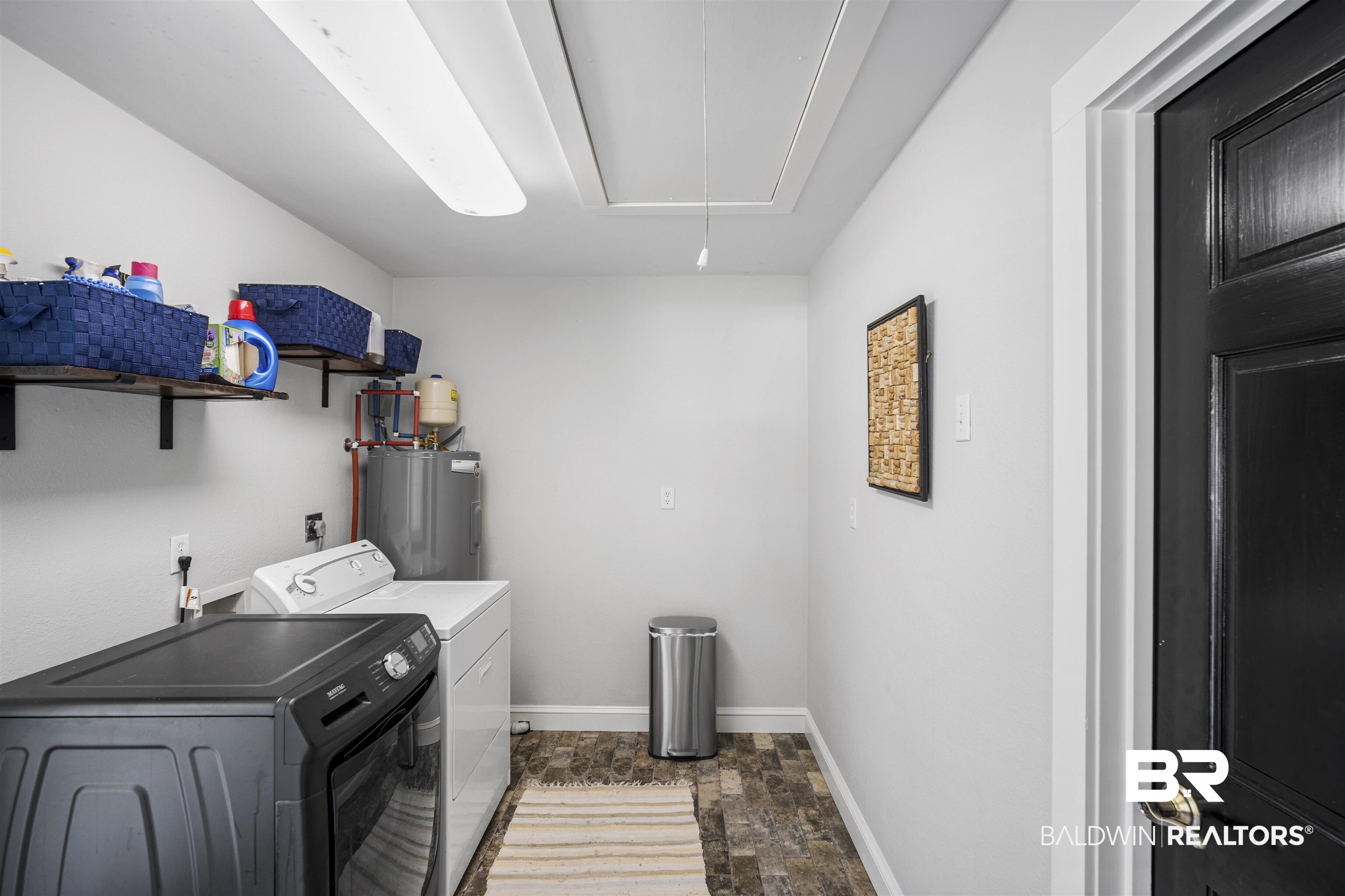 1615 5th Street Daphne, AL 36526 - Photo 24 of 28 Dedicated utility space featuring durable tile flooring, a water heater, and wall-mounted shelving