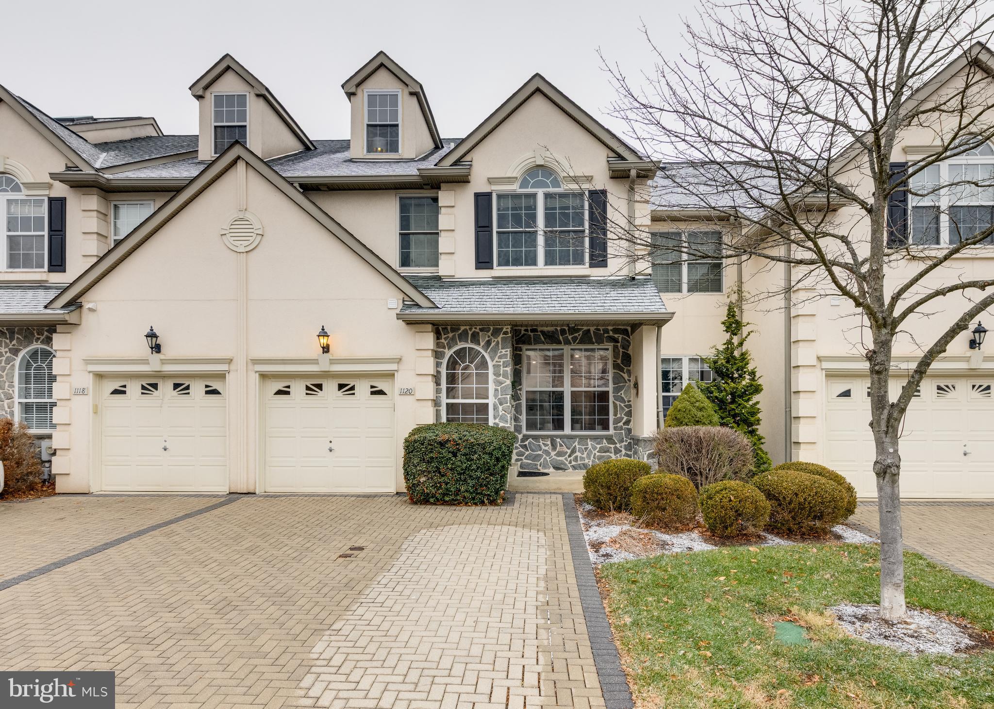 a view of a white house with a large windows and a yard