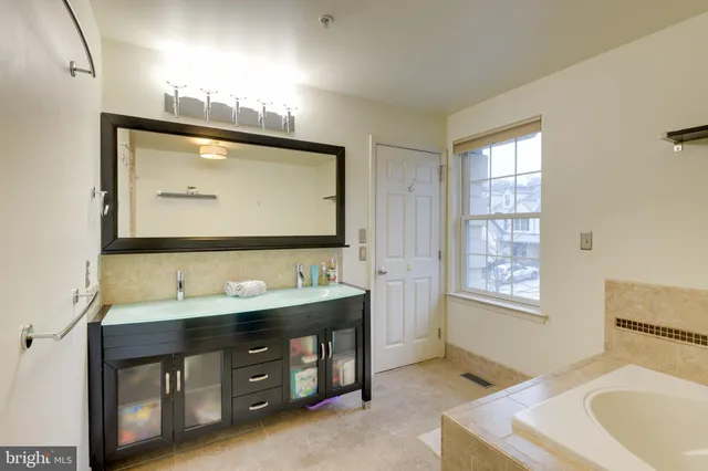 a bathroom with a double vanity sink and a mirror