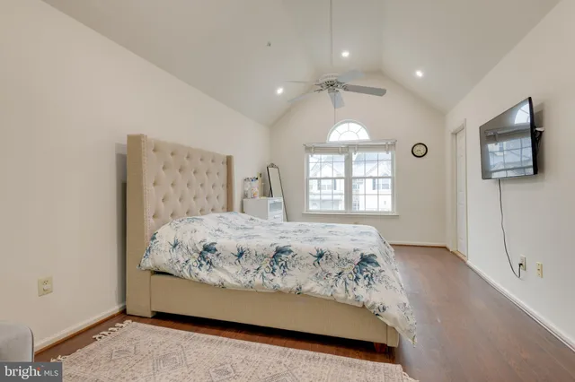 a bedroom with a bed mirror and window