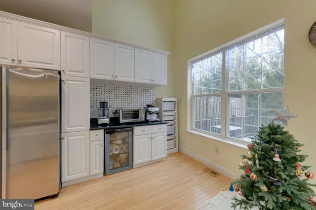 a kitchen with stainless steel appliances a refrigerator sink and cabinets