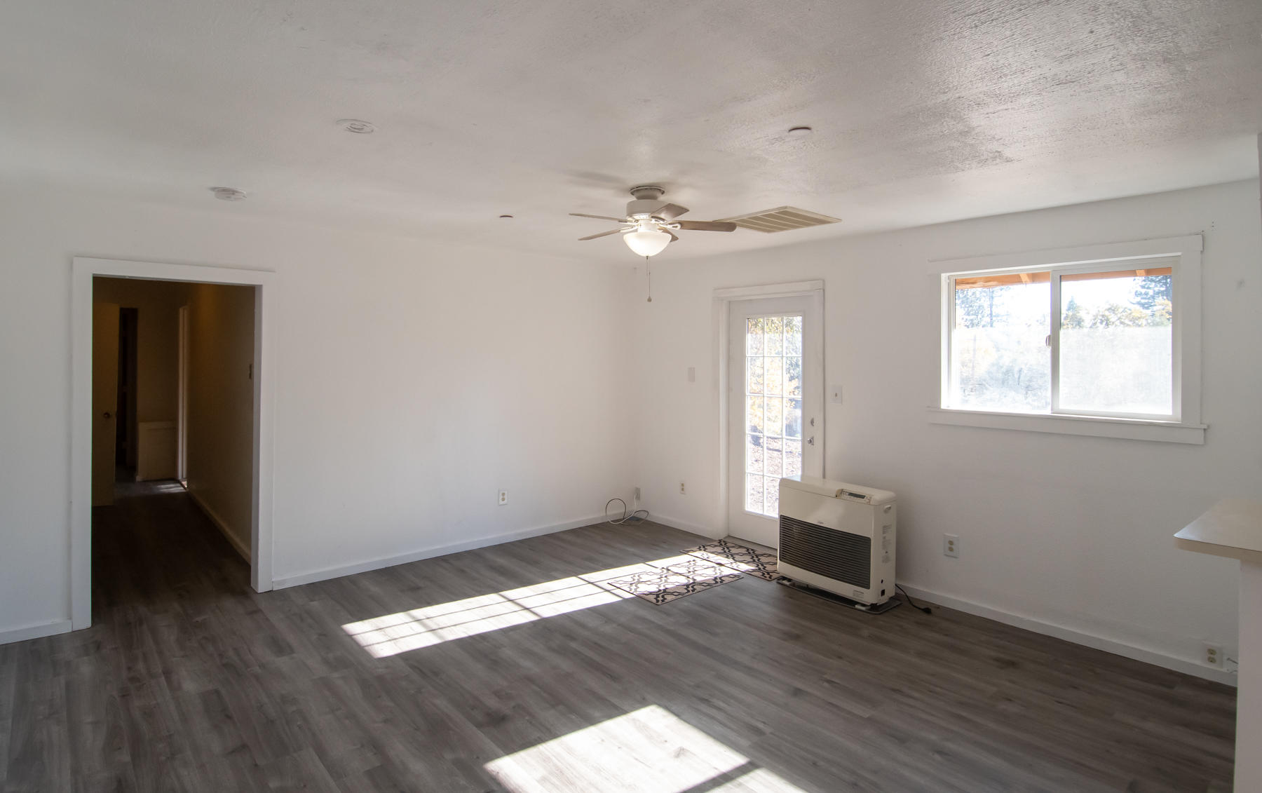 14681 Fern Road Whitmore, CA 96096 - Photo 13 of 37 an empty room with wooden floor and windows