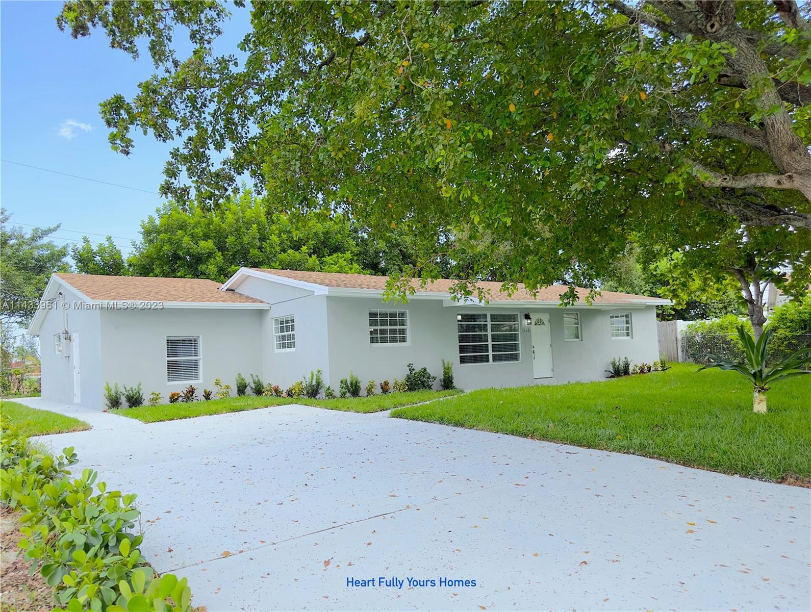 1460 Southwest 3rd Terrace Deerfield Beach, FL 33441 - Photo 1 of 100 a front view of house with yard and green space