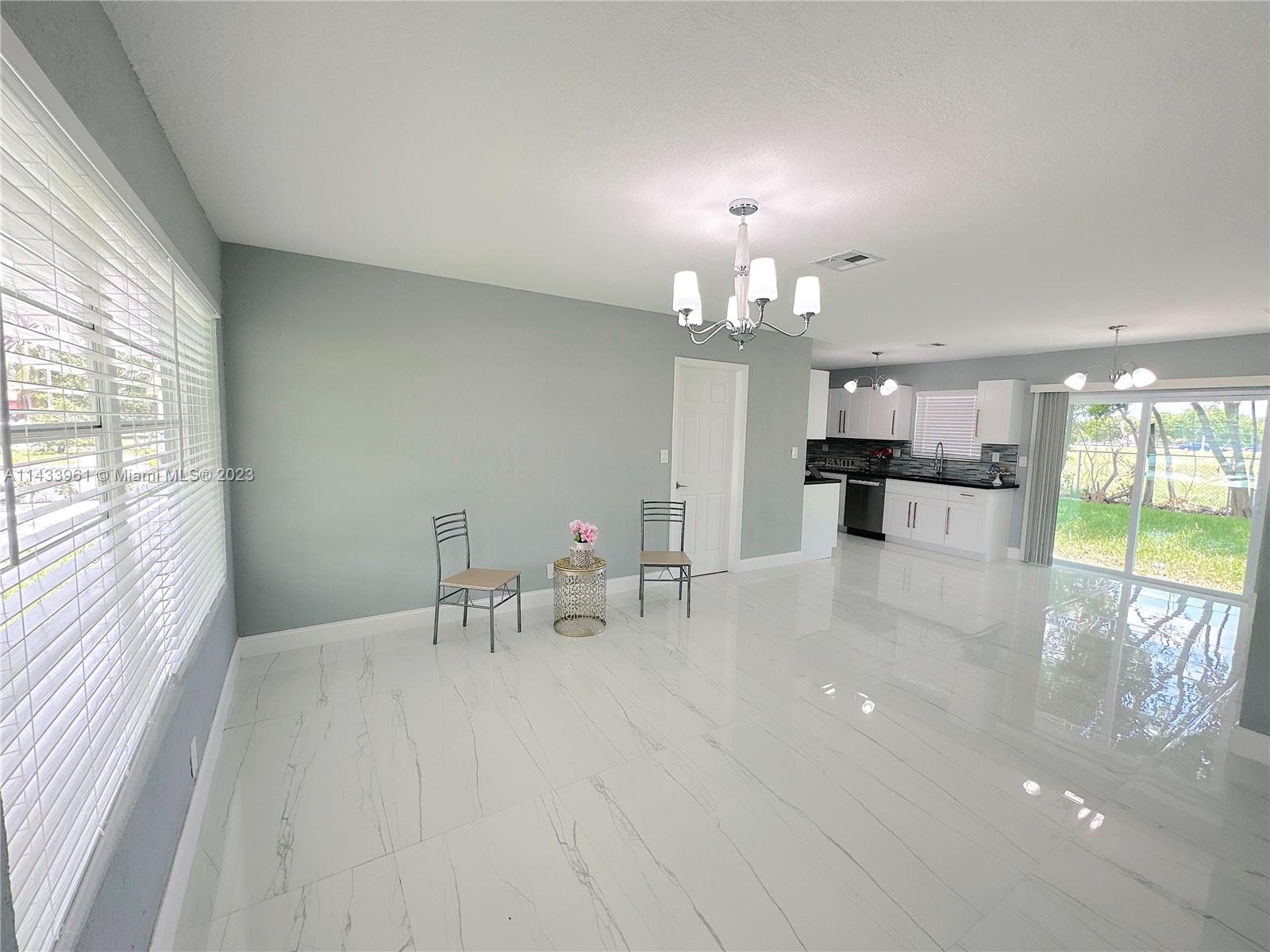 1460 Southwest 3rd Terrace Deerfield Beach, FL 33441 - Photo 14 of 100 a view of a dining room with furniture and a chandelier