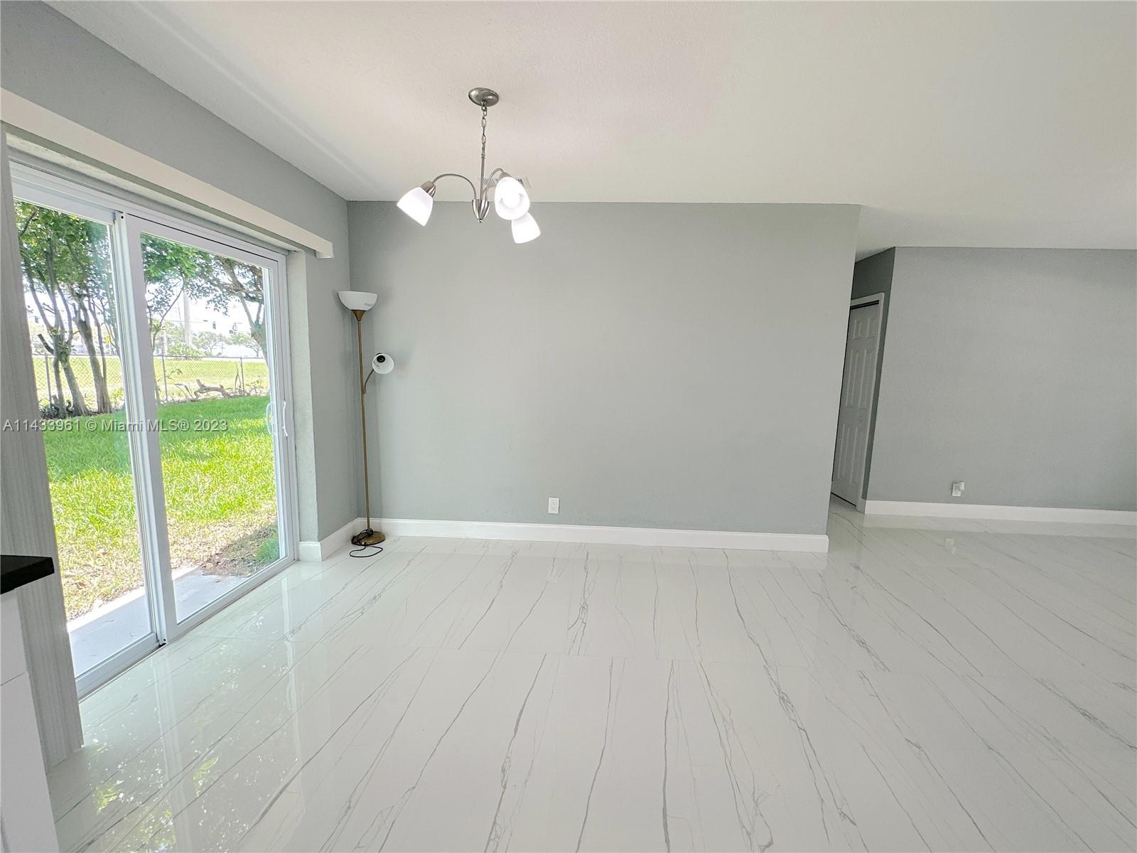 1460 Southwest 3rd Terrace Deerfield Beach, FL 33441 - Photo 20 of 100 wooden floor in an empty room with a window