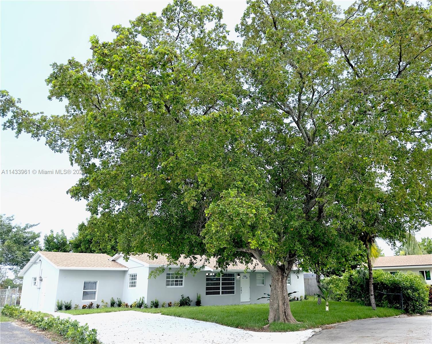 1460 Southwest 3rd Terrace Deerfield Beach, FL 33441 - Photo 2 of 100 a front view of a house with a yard