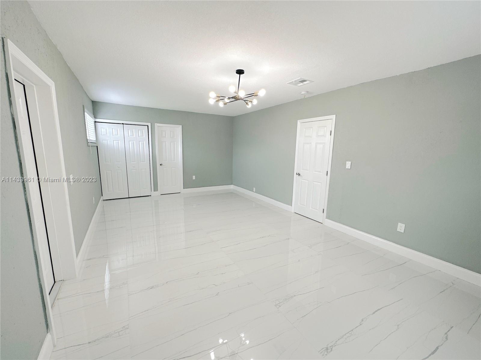 1460 Southwest 3rd Terrace Deerfield Beach, FL 33441 - Photo 37 of 100 wooden floor in an empty room with a window
