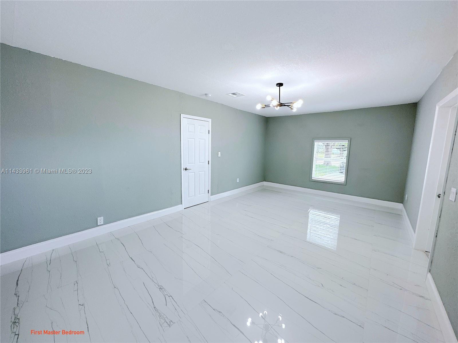 1460 Southwest 3rd Terrace Deerfield Beach, FL 33441 - Photo 38 of 100 wooden floor in an empty room with a window