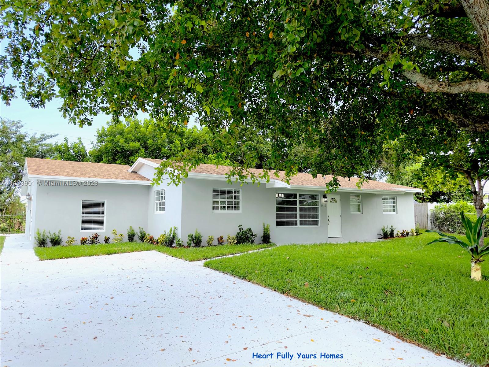 1460 Southwest 3rd Terrace Deerfield Beach, FL 33441 - Photo 4 of 100 a front view of house with yard and green space