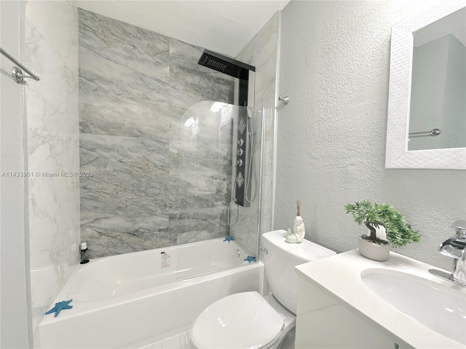 1460 Southwest 3rd Terrace Deerfield Beach, FL 33441 - Photo 42 of 100 a bathroom with a sink toilet and bathtub