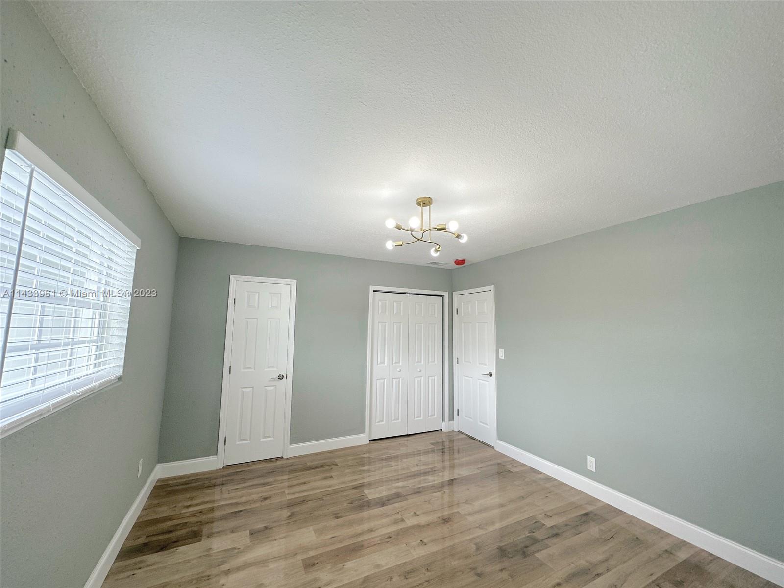1460 Southwest 3rd Terrace Deerfield Beach, FL 33441 - Photo 47 of 100 an empty room with windows and closet