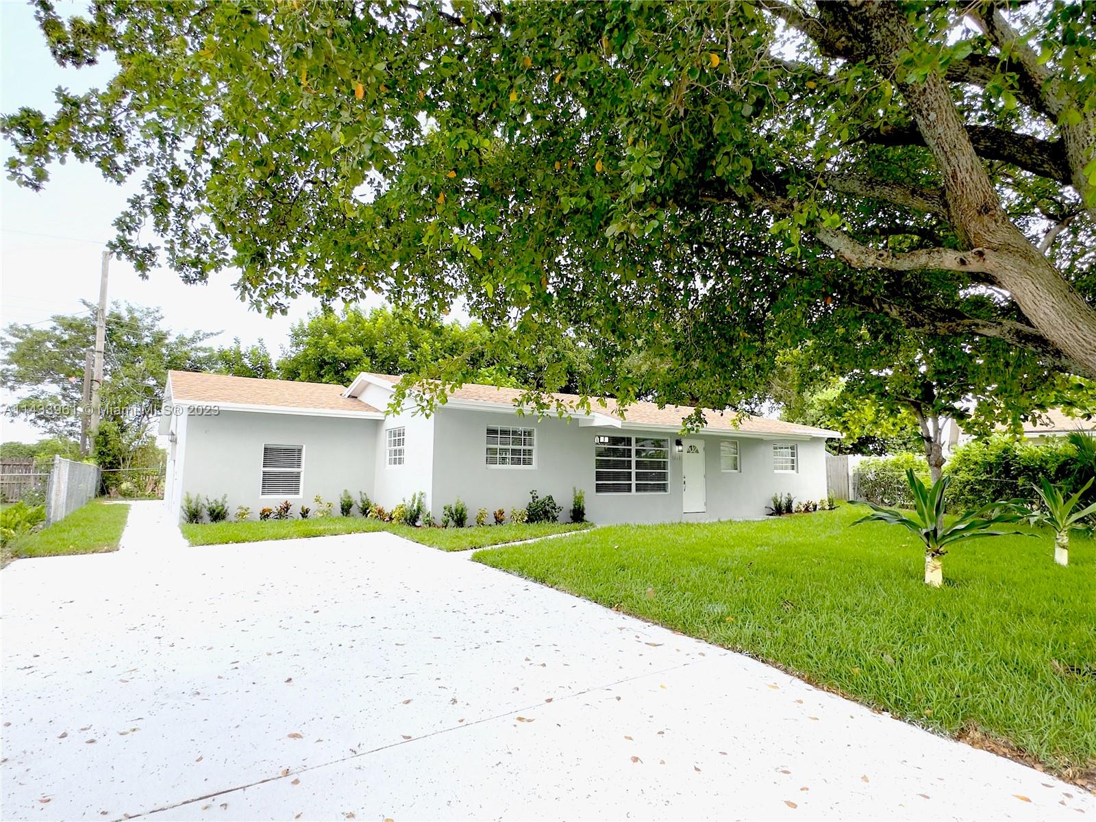 1460 Southwest 3rd Terrace Deerfield Beach, FL 33441 - Photo 5 of 100 a front view of a house with a patio