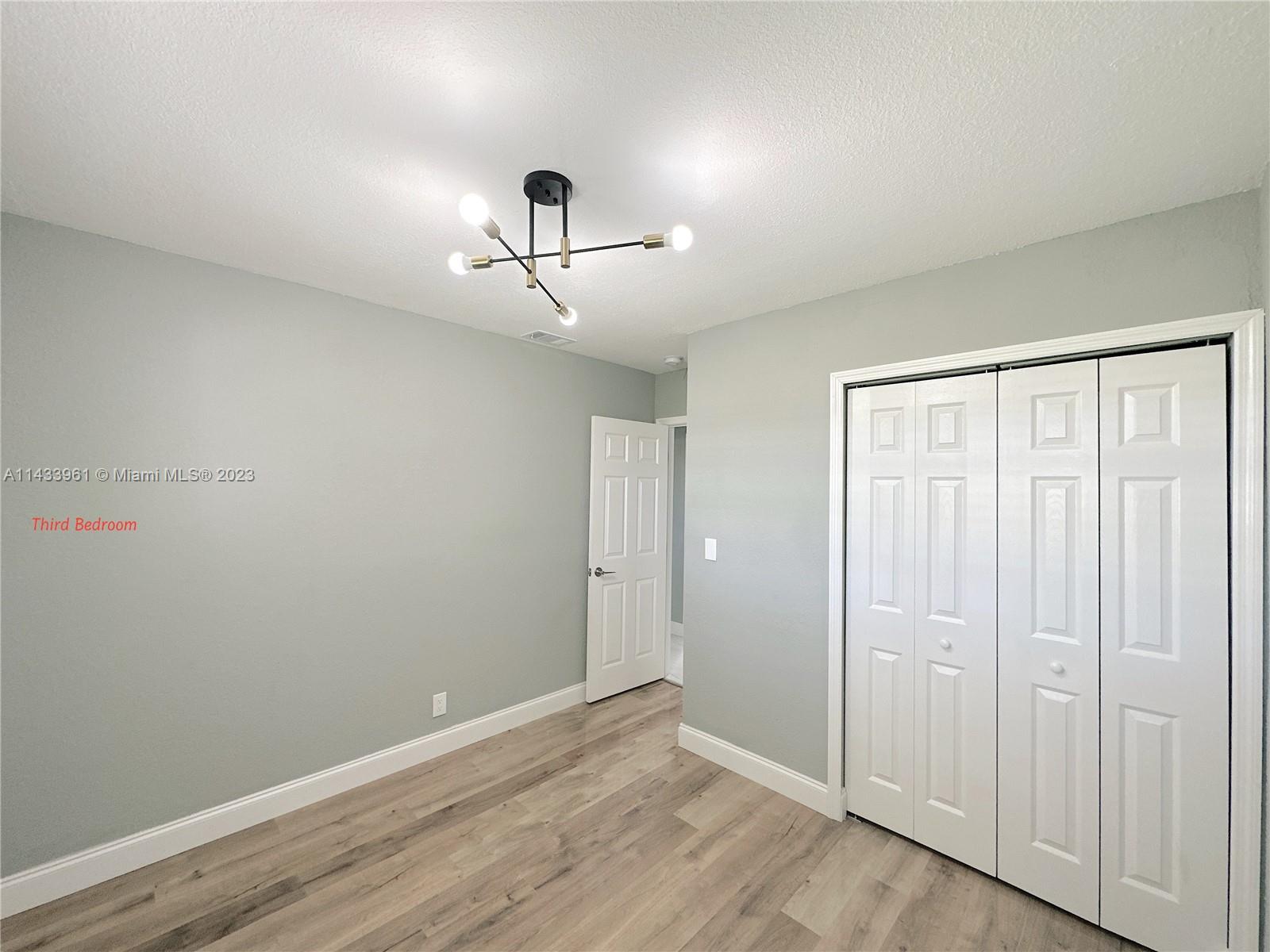 1460 Southwest 3rd Terrace Deerfield Beach, FL 33441 - Photo 55 of 100 a view of room with hardwood floor and ceiling fan