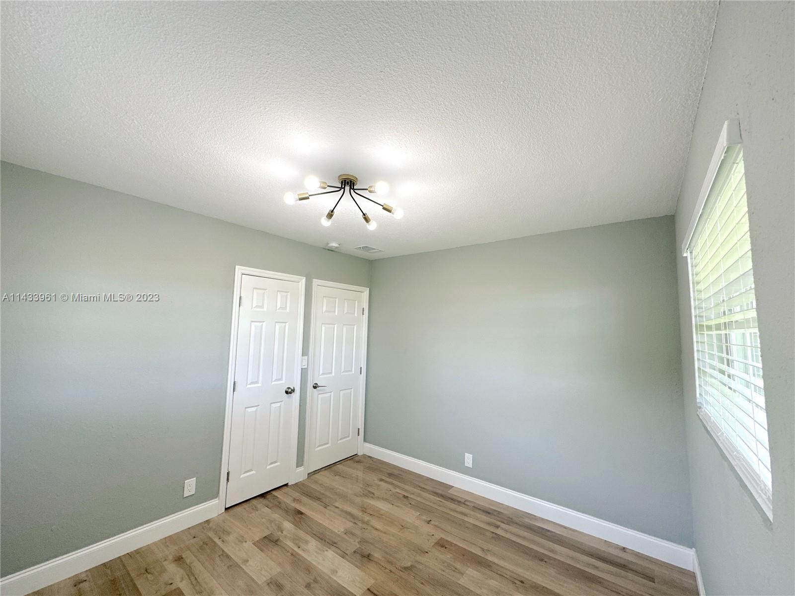 1460 Southwest 3rd Terrace Deerfield Beach, FL 33441 - Photo 62 of 100 wooden floor in an empty room with a window