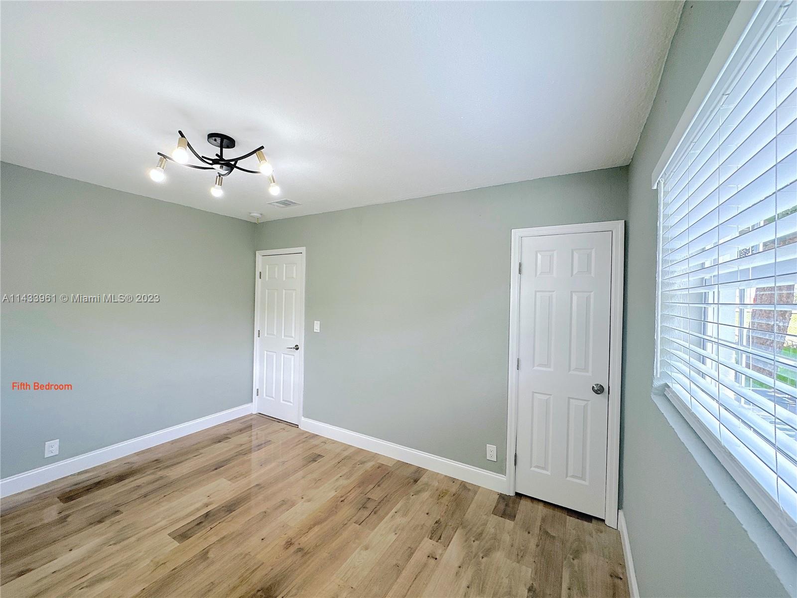 1460 Southwest 3rd Terrace Deerfield Beach, FL 33441 - Photo 67 of 100 wooden floor in an empty room with a window