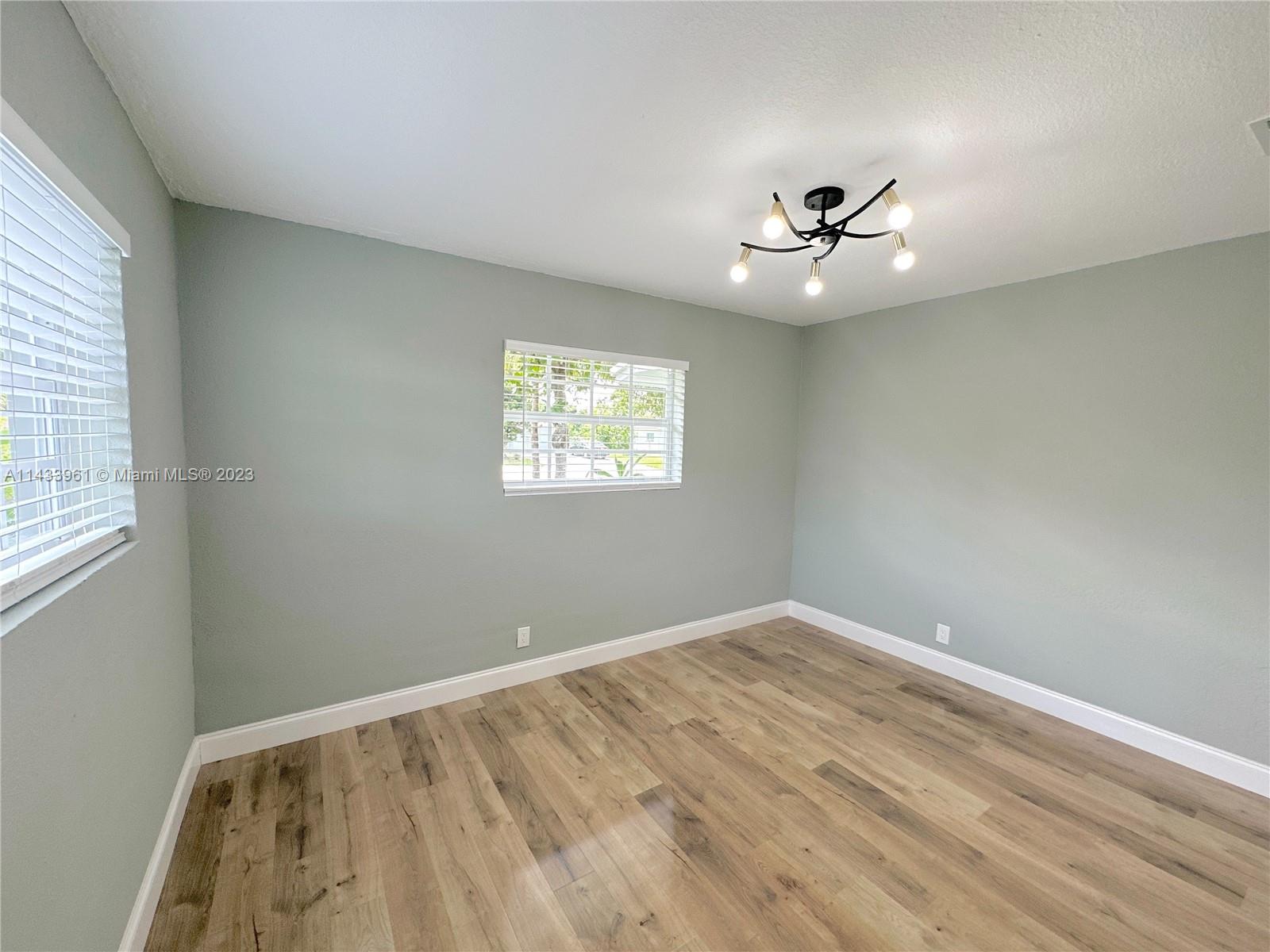 1460 Southwest 3rd Terrace Deerfield Beach, FL 33441 - Photo 68 of 100 an empty room with windows and fan
