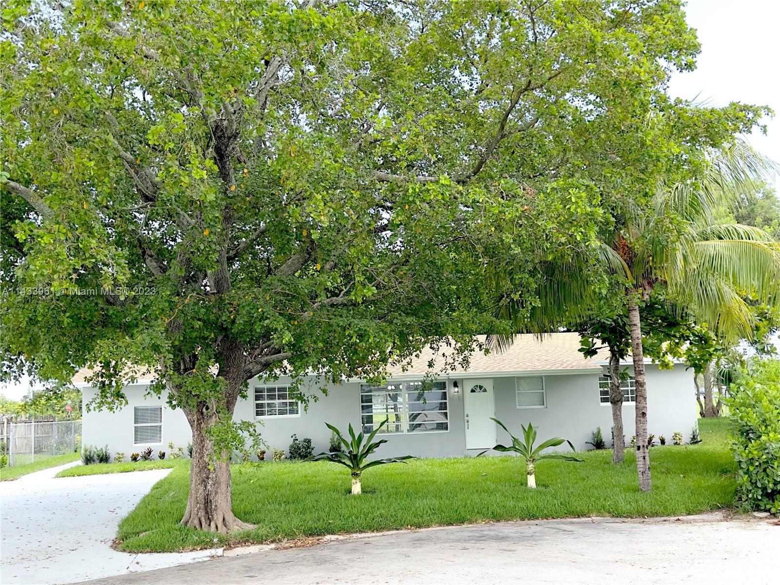 1460 Southwest 3rd Terrace Deerfield Beach, FL 33441 - Photo 7 of 100 a front view of a house with a yard