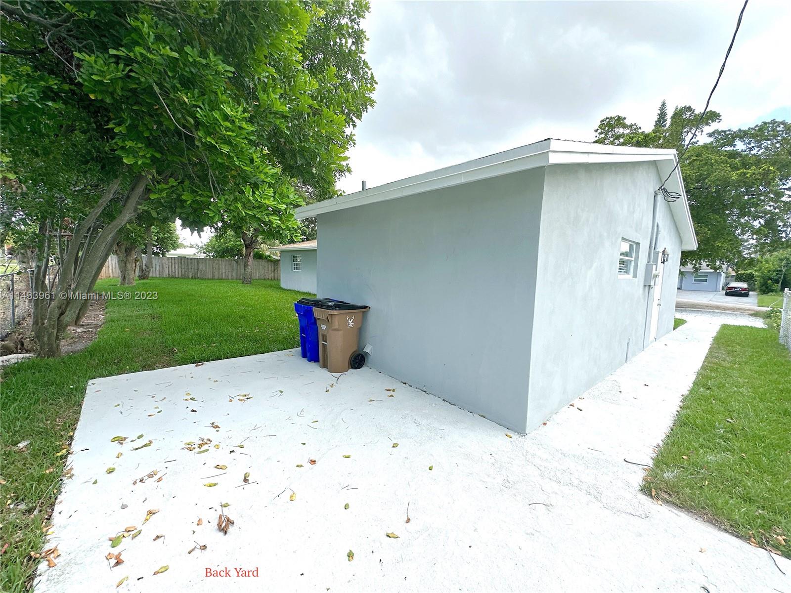 1460 Southwest 3rd Terrace Deerfield Beach, FL 33441 - Photo 76 of 100 a front view of a house with a yard