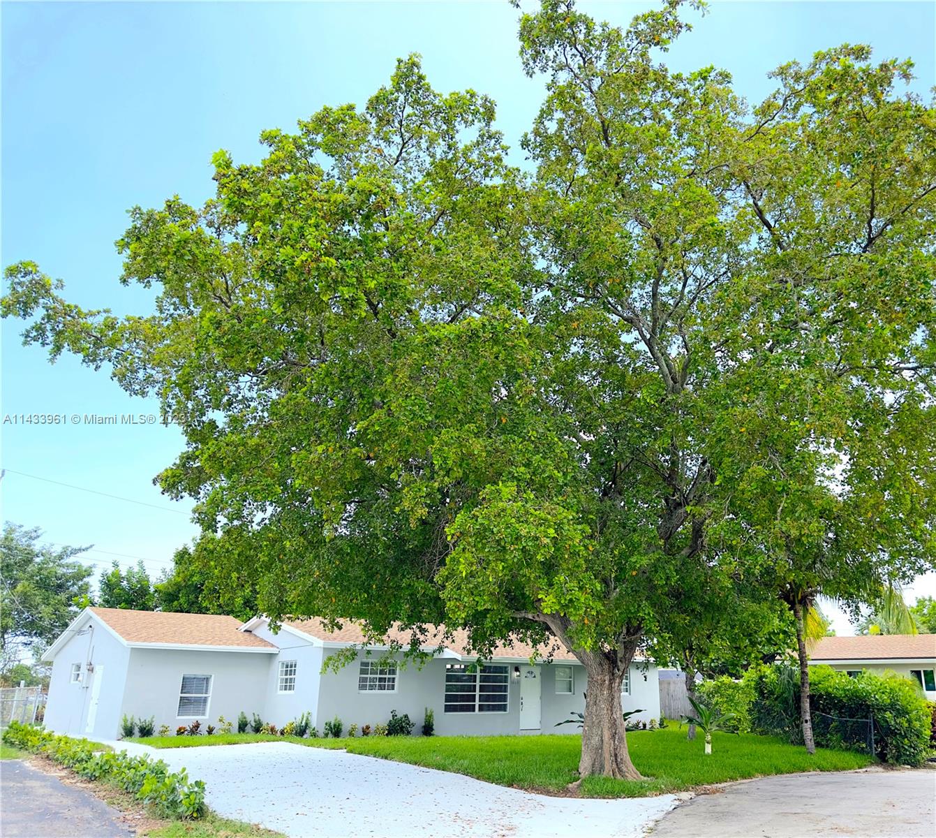 1460 Southwest 3rd Terrace Deerfield Beach, FL 33441 - Photo 8 of 100 a front view of a house with a garden and tree