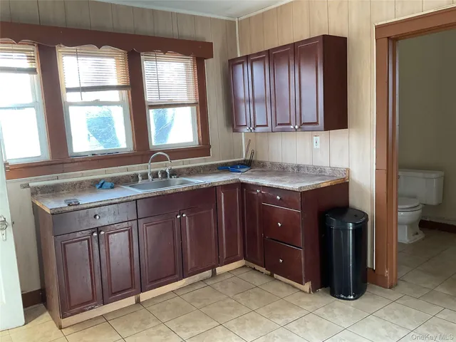 a kitchen with a sink window and cabinets