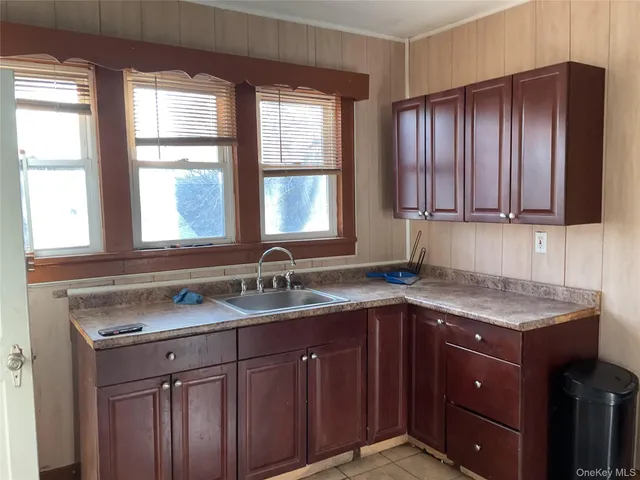 a kitchen with stainless steel appliances granite countertop cabinets sink and window