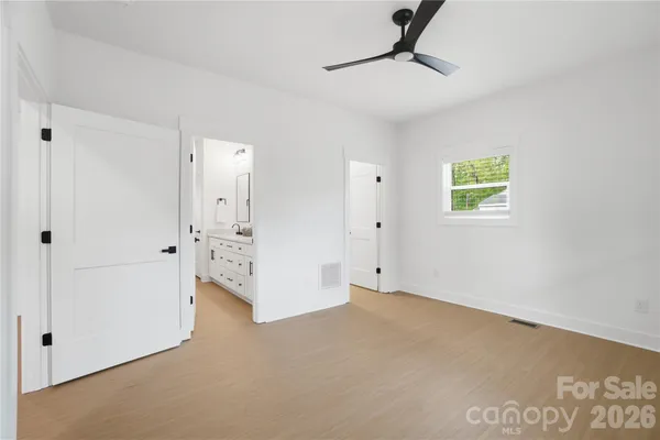 an empty room with windows and closet