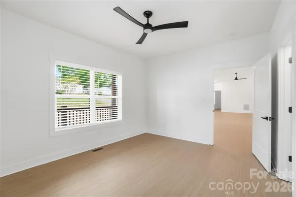 a view of a room with a ceiling fan and a window