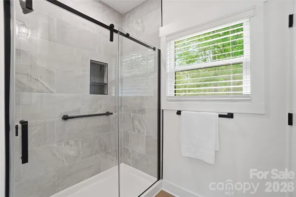 a bathroom with a shower and a window