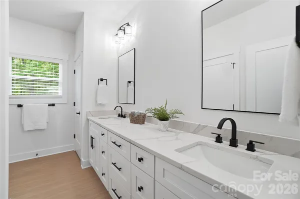 a bathroom with double vanity sink and a mirror