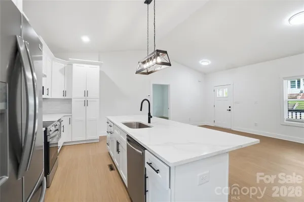 a kitchen with a sink and refrigerator