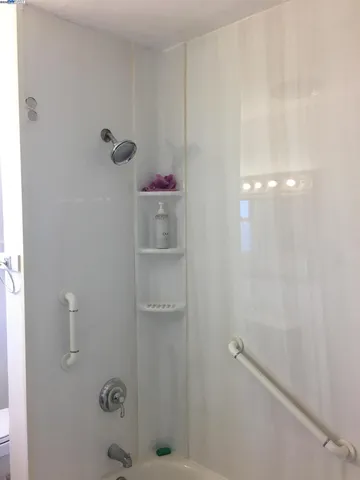 a bathroom with a sink vanity granite and a mirror