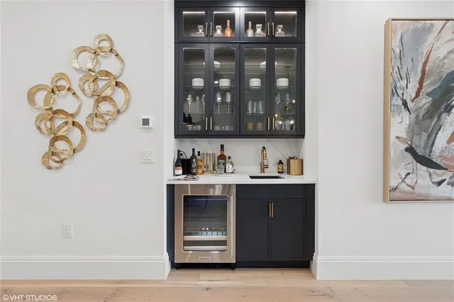 a kitchen with a sink a counter space appliances and cabinets