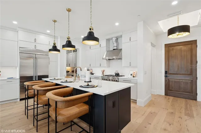 a kitchen with a stove and a white cabinets