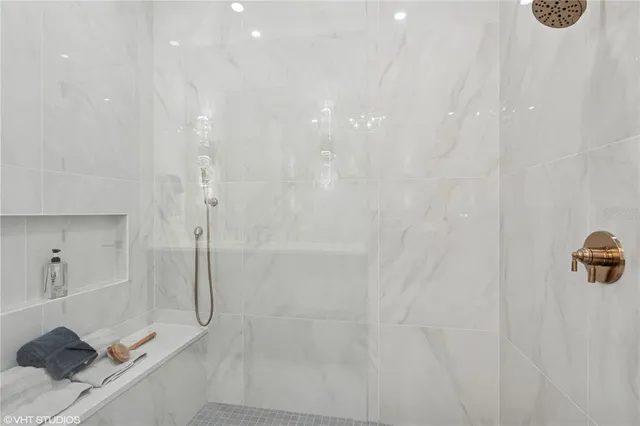 a spacious bathroom with a double vanity sink mirror and shower